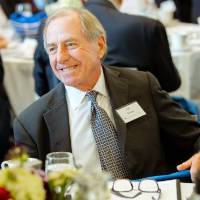 Guest sitting at a table at the Foundation Annual Meeting